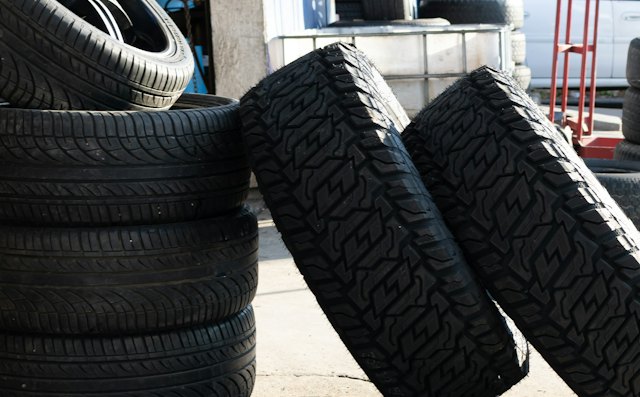 New tires stacked outside a tire shop service bay