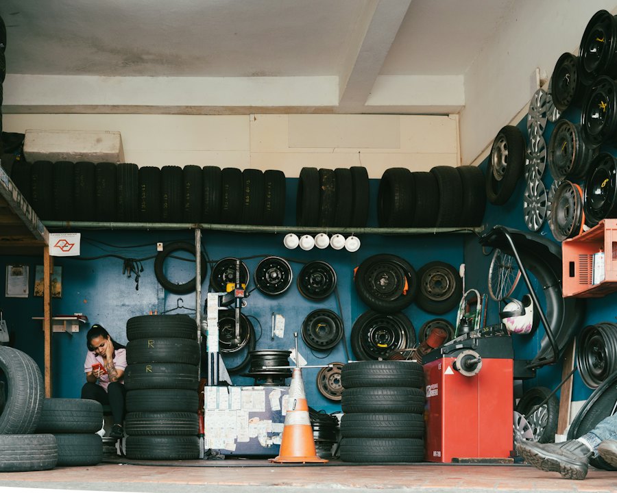 Interior of a tire shop with tires and wheels on the walls