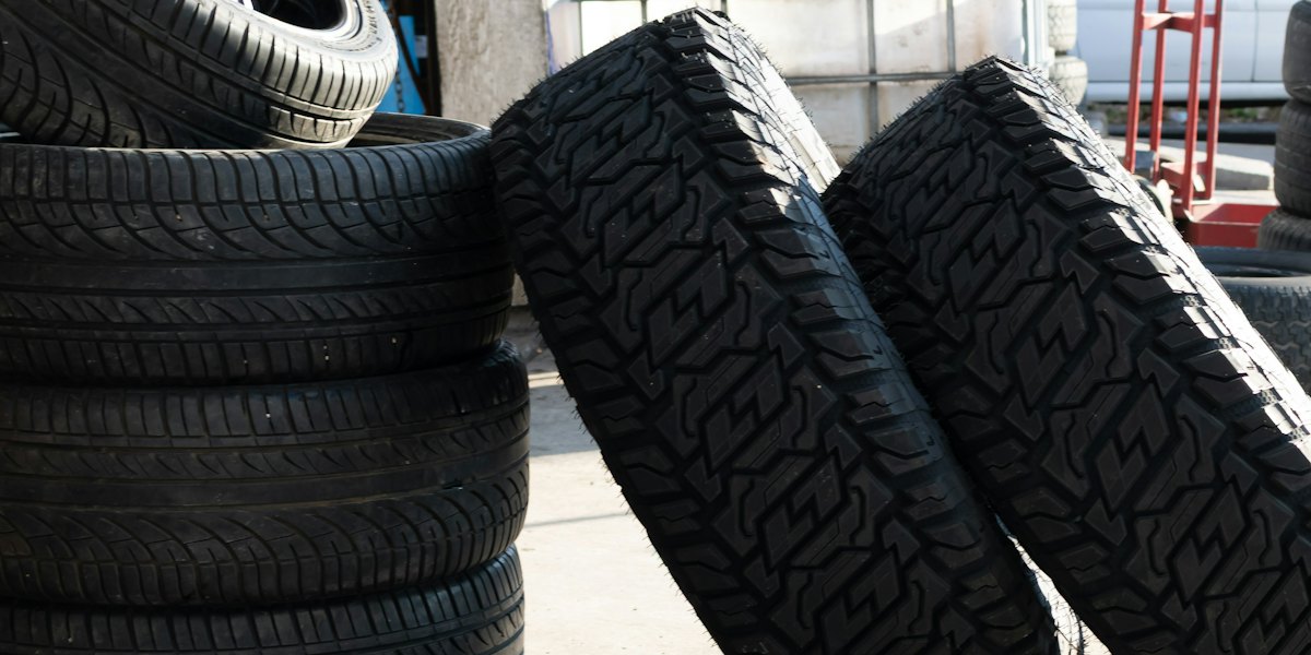 New tires stacked outside a tire shop service bay